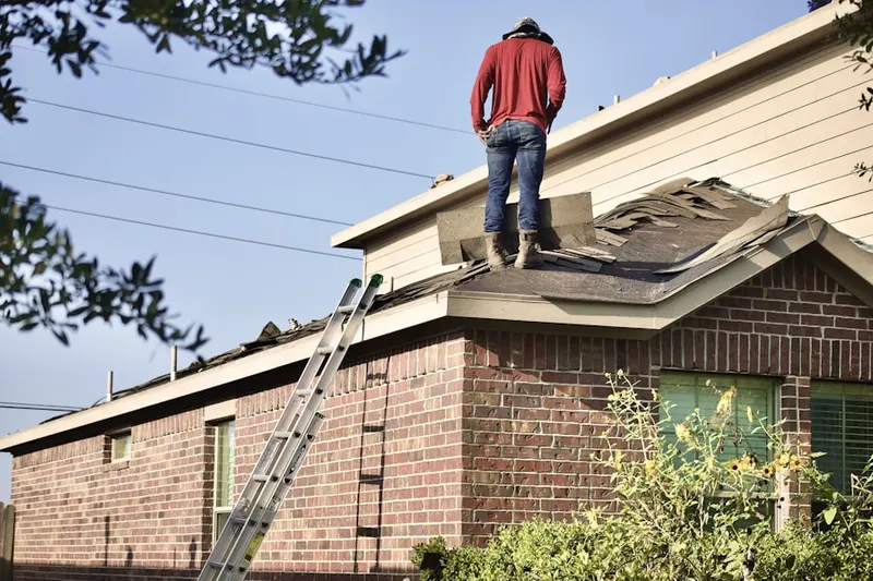 Professional roofer working on a residential roof in Harmony Hall